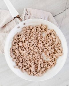 Savor cooked 93/7 ground turkey in a white skillet with macro data labels for Protein, Fat, and Calories, reinforcing the 93/7 Ground Turkey Nutrition