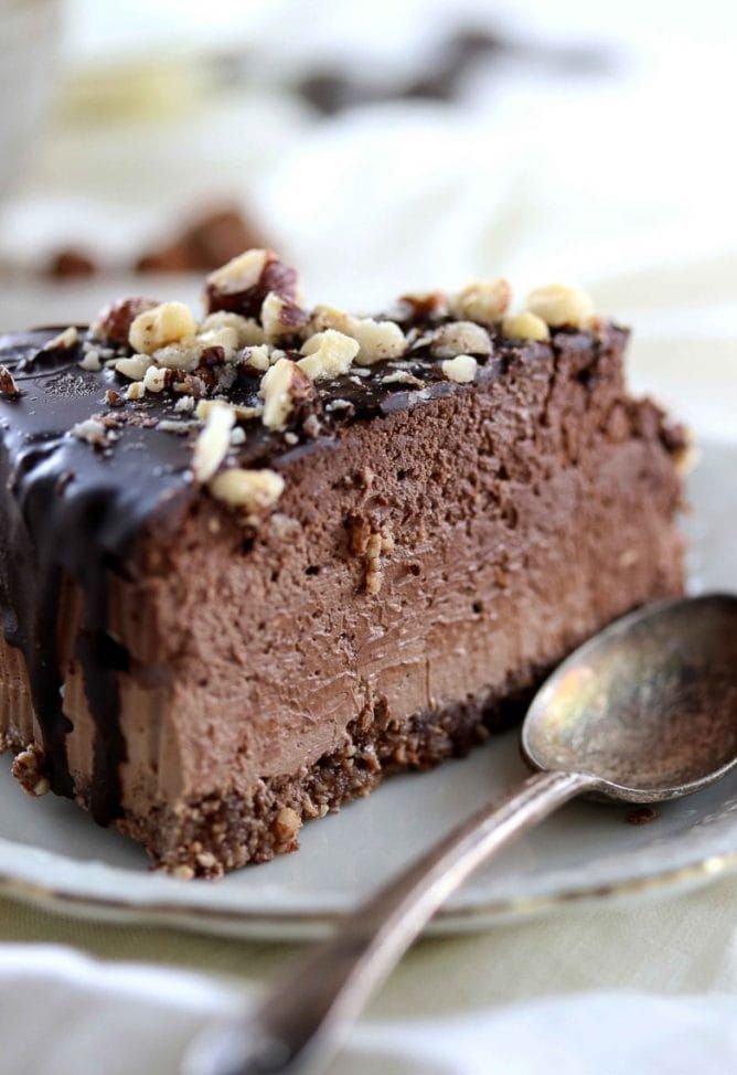 A decadent slice of no-bake chocolate mousse cake, topped with a rich glaze and chopped nuts, is a prime example of the delicious possibilities you'll find in our collection of Keto Desserts Recipes.